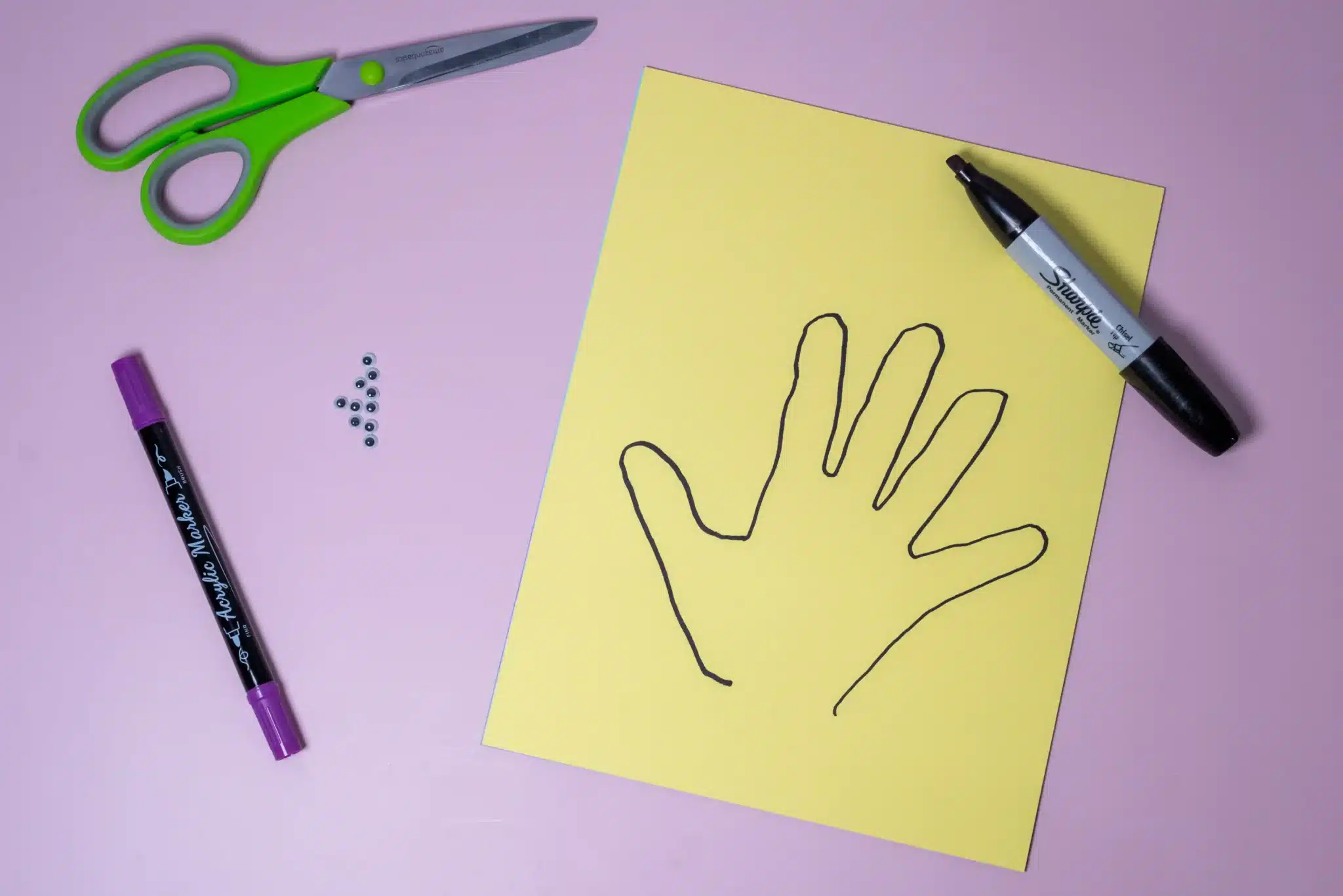 Bunny Handprint Craft - Cultivating Brilliant Minds a kids handprint traced on yellow paper