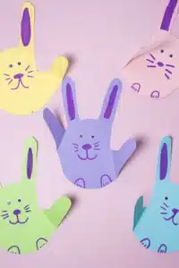 a bunny handprint craft that is a handprint cut out of construction paper decorated to look like a bunny