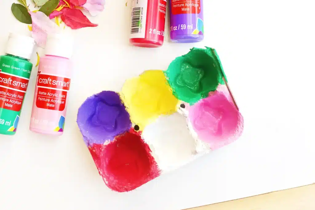 Spring Flower Fine Motor Activity - Cultivating Brilliant Minds an egg carton with the cups painted different colors for the spring nature activity for kids