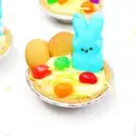 Peeps Banana Pudding Mini Pies - Cultivating Brilliant Minds a banana pudding mini pie with nilla wafers, edible grass, jelly beans, and a peeps bunny