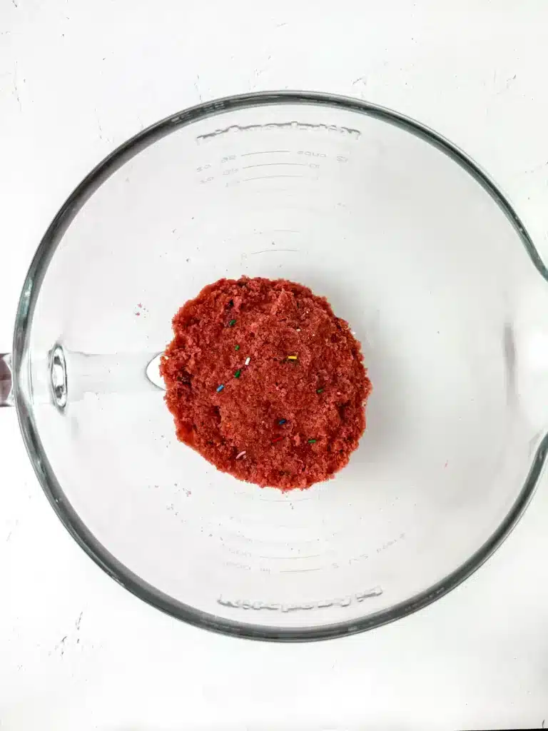 a mixture of strawberry cupcakes and rainbow sprinkles