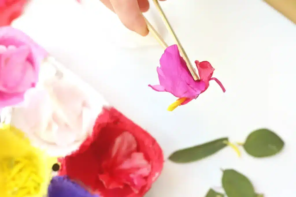 Spring Flower Fine Motor Activity - Cultivating Brilliant Minds a kid using tweezers to pick up flower petals