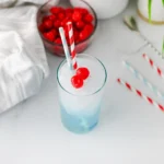 Copycat Sonic Ocean Water with a cherry and straw on a kitchen counter