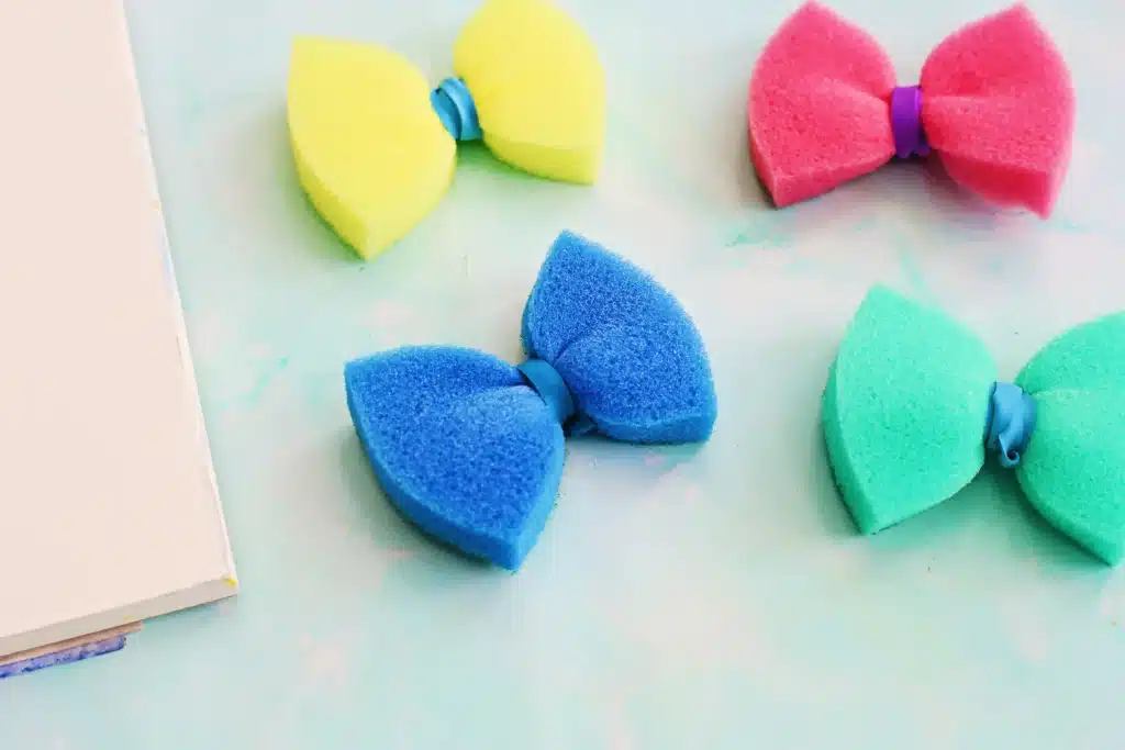 Sponge Painted Butterflies - Cultivating Brilliant Minds sponges with rubber bands around the middle to look like a butterfly