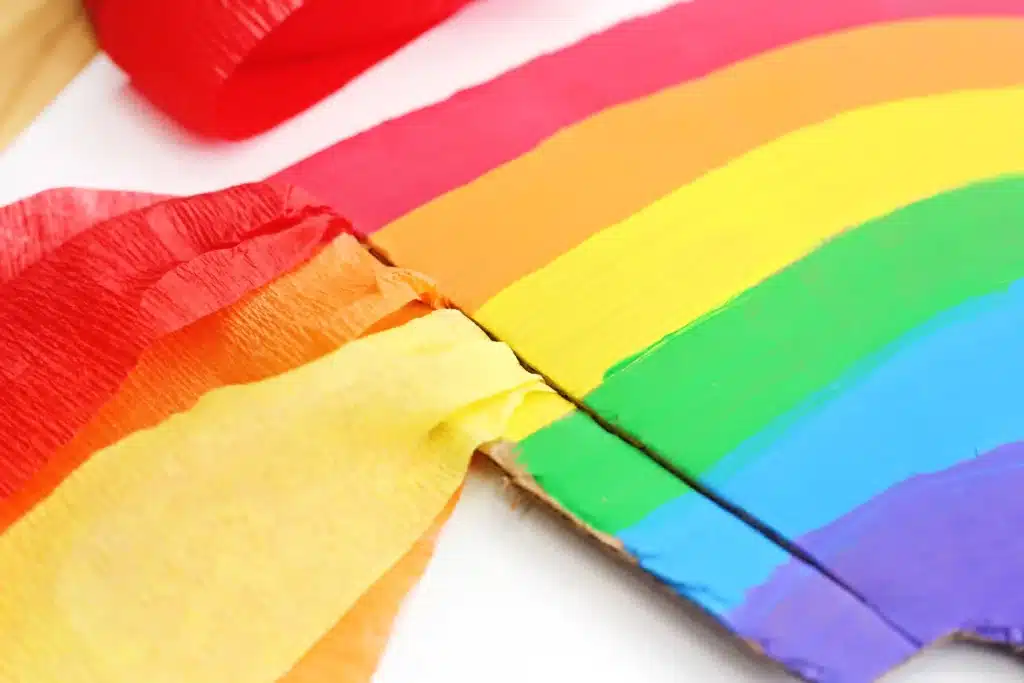Cardboard Rainbow Streamers - Cultivating Brilliant Minds streamers put through a slit cut at the bottom of the cardboard rainbow
