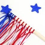 an American flag wand fourth of july craft that uses string tied around a dowel and a star button