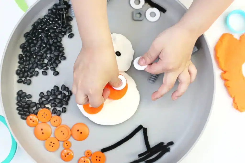 BB8 Playdough Tray - Cultivating Brilliant Minds a kid building bb8 from star wars out of playdough