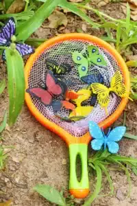 a butterfly net with fake butterflies inside