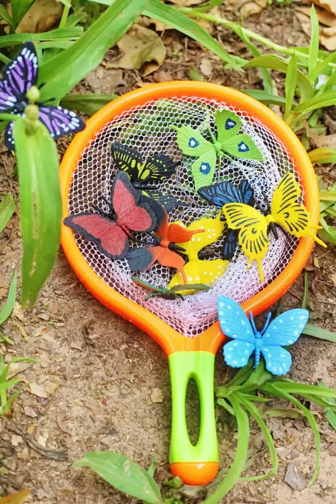 Backyard Butterfly Hunt - Cultivating Brilliant Minds a butterfly net with fake butterflies inside for the butterfly hunt activity.
