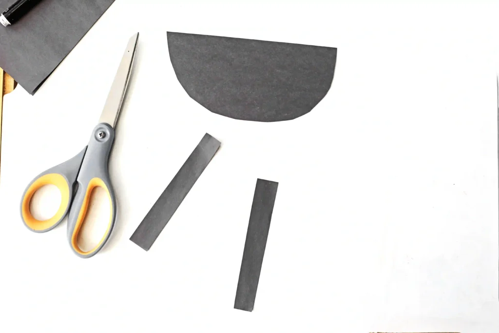 Father's Day Handprint Craft - Cultivating Brilliant Minds black construction paper cut into tow rectangles and a semi circle