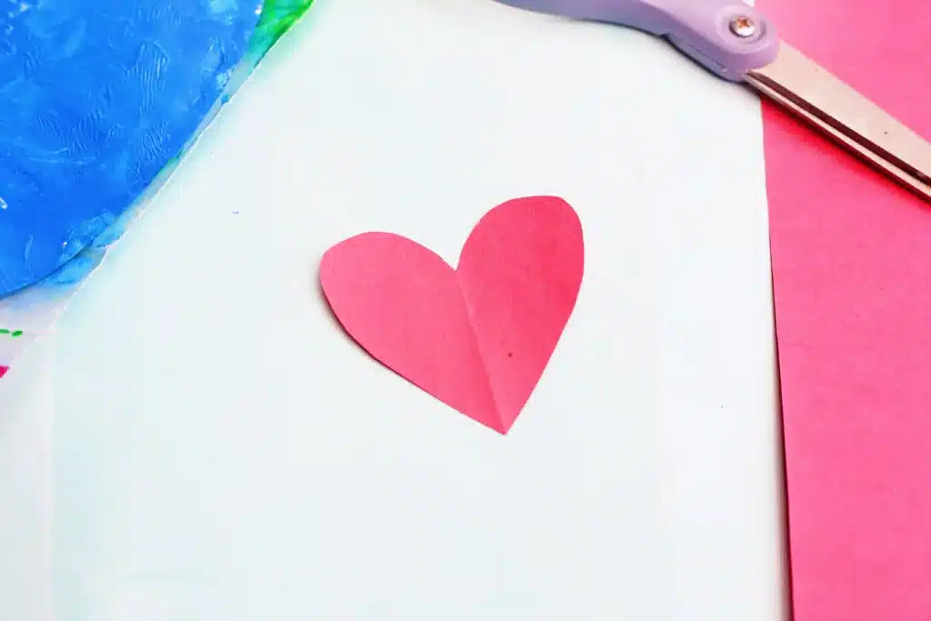 No-Mess Earth Day Painting - Cultivating Brilliant Minds a red heart cut out of construction paper