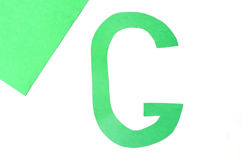 Letter G Grape Craft - Cultivating Brilliant Minds Close-up of a bright green letter G cutout on a white background