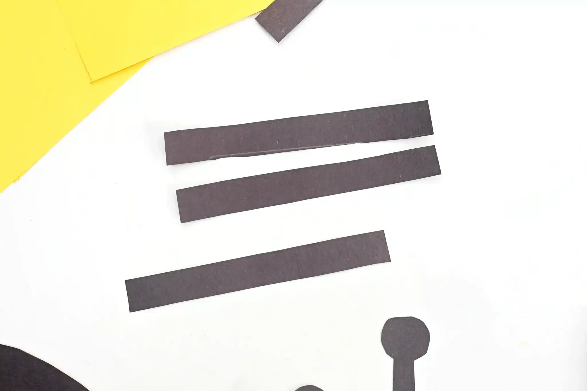Letter B Bee Craft - Cultivating Brilliant Minds strips of black construction paper