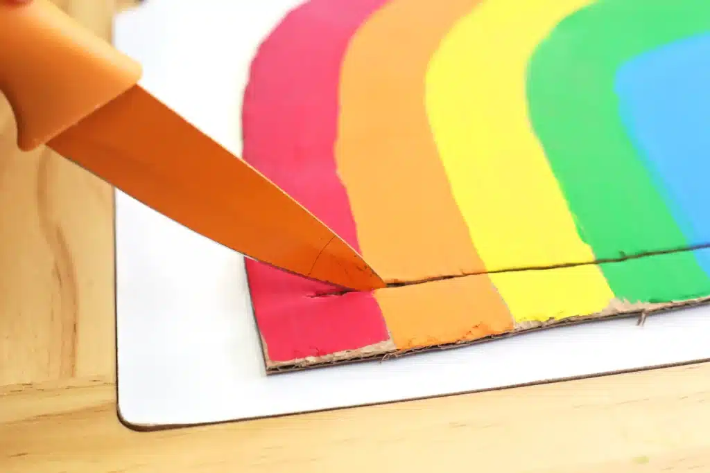 Cardboard Rainbow Streamers - Cultivating Brilliant Minds a slit cut in the bottom of the cardboard rainbow