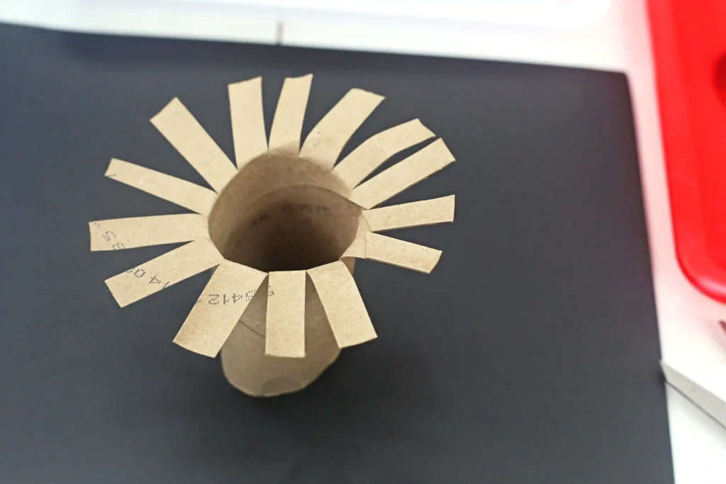 Toilet Paper Roll Firework Craft - Cultivating Brilliant Minds a toilet paper roll cut to look like fireworks