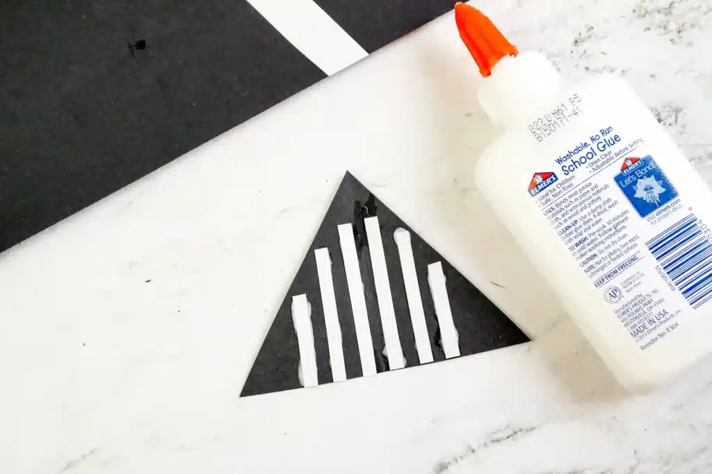 Darth Vader Hat - Cultivating Brilliant Minds a black triangle with white lines