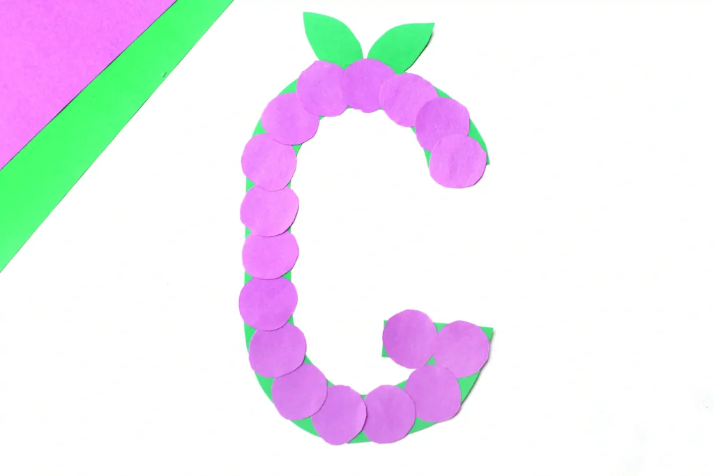 Letter G Grape Craft - Cultivating Brilliant Minds a letter g craft for preschoolers of a construction paper g with purple circles to represent grapes