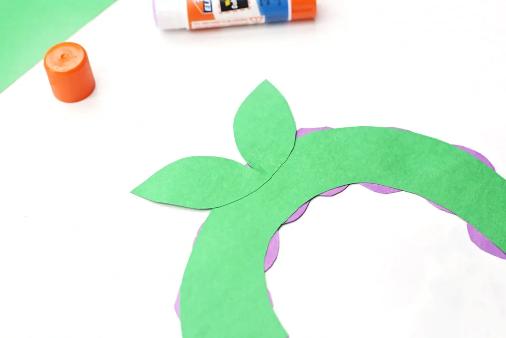 Letter G Grape Craft - Cultivating Brilliant Minds Green paper leaves glued to a green letter g