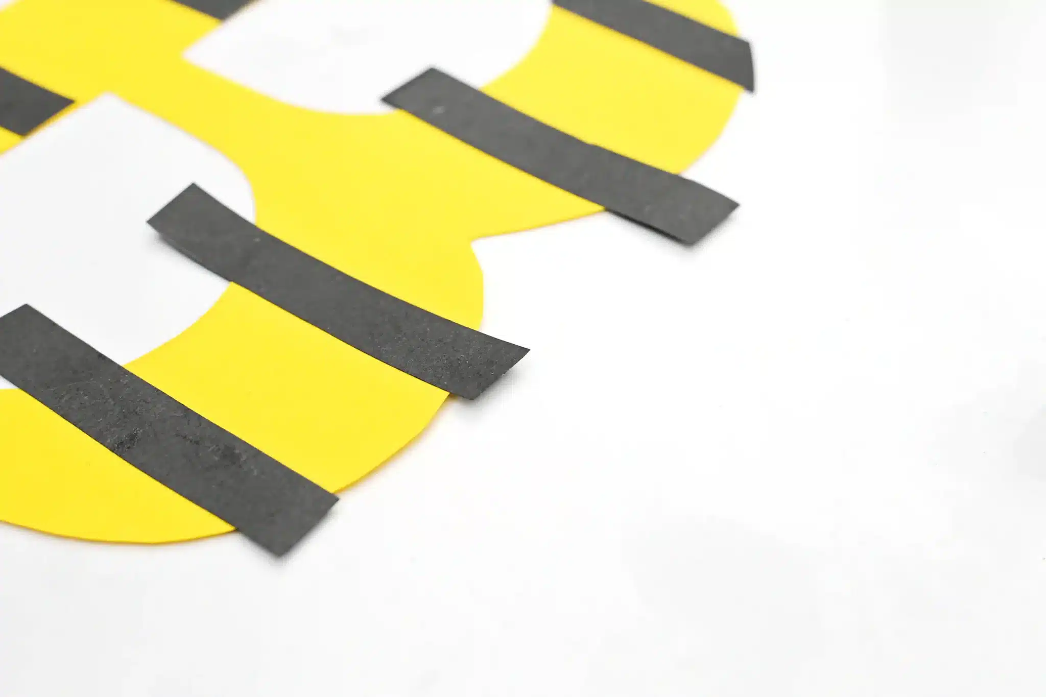 Letter B Bee Craft - Cultivating Brilliant Minds a letter b cut out of yellow construction paper with black construction paper stripes