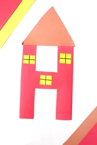 a letter h cut out of construction paper and decorated to look like a house