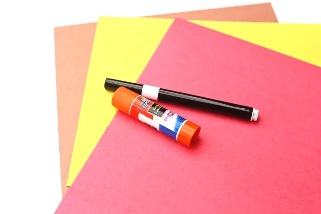 Letter H House Craft - Cultivating Brilliant Minds red, yellow, and orange construction paper, a black marker, and a glue stick