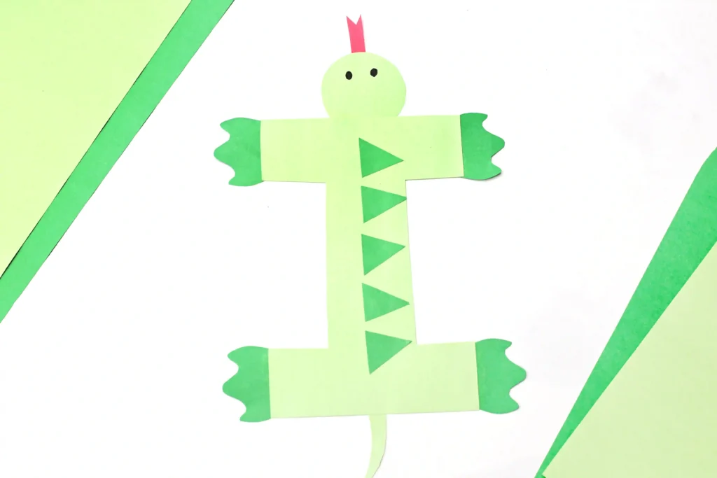 Letter I Iguana Craft - Cultivating Brilliant Minds a letter i cut out of green construction paper and decorated to look like an iguana