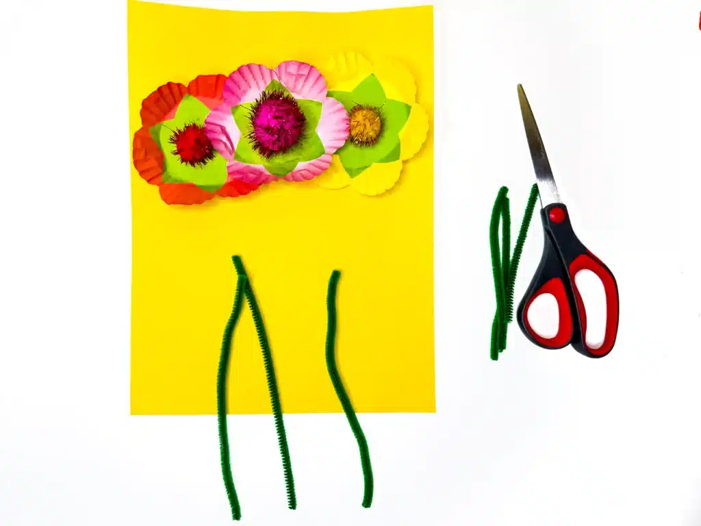 Cupcake Liner Flower Craft - Cultivating Brilliant Minds a cupcake liner flower craft that uses cupcake liners and pom poms as the flowers and pipe cleaners for the stems