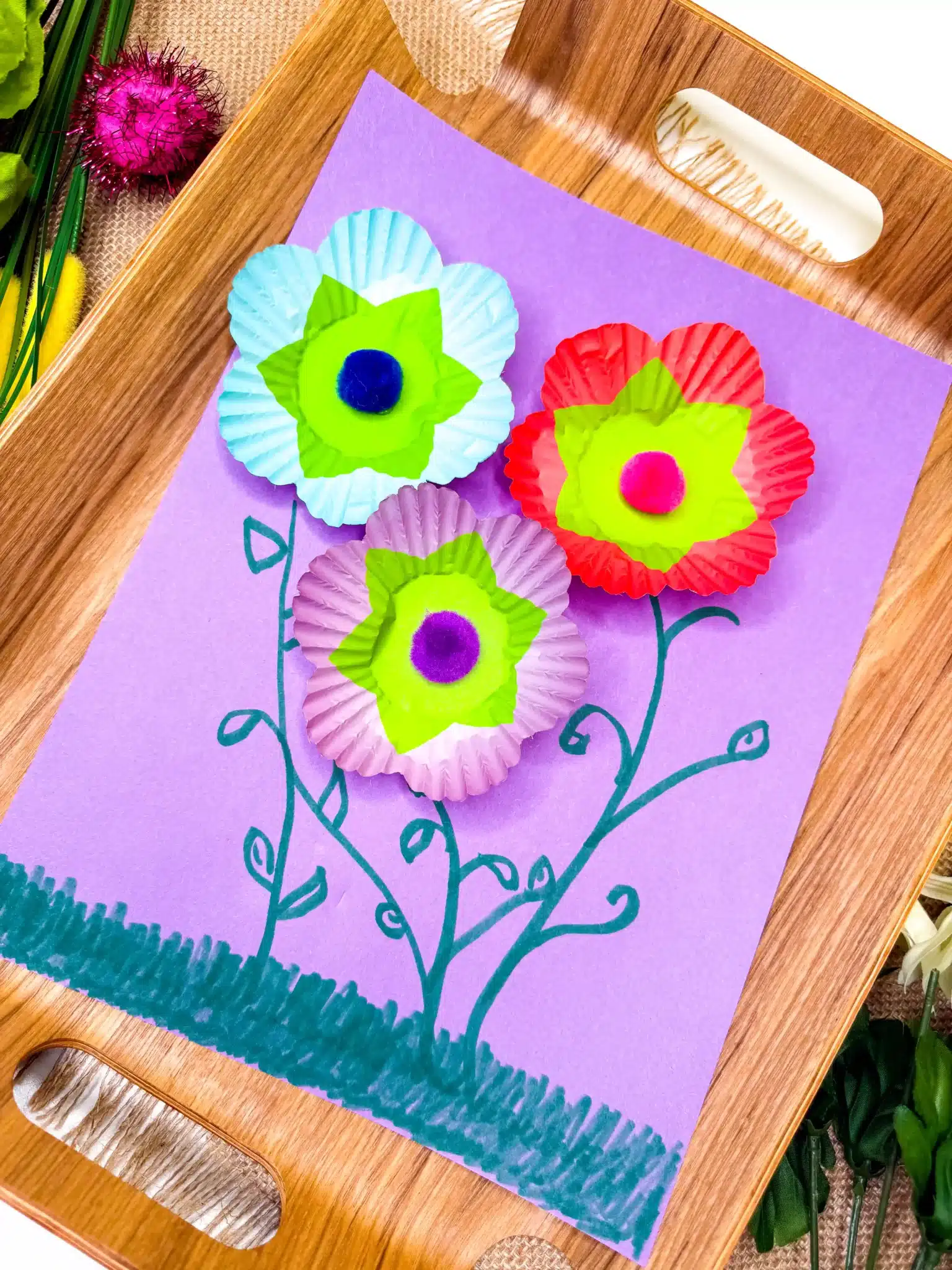 Cupcake Liner Flower Craft - Cultivating Brilliant Minds a cupcake liner flower craft that uses cupcake liners and pom poms as the flowers and green marker to draw the stems