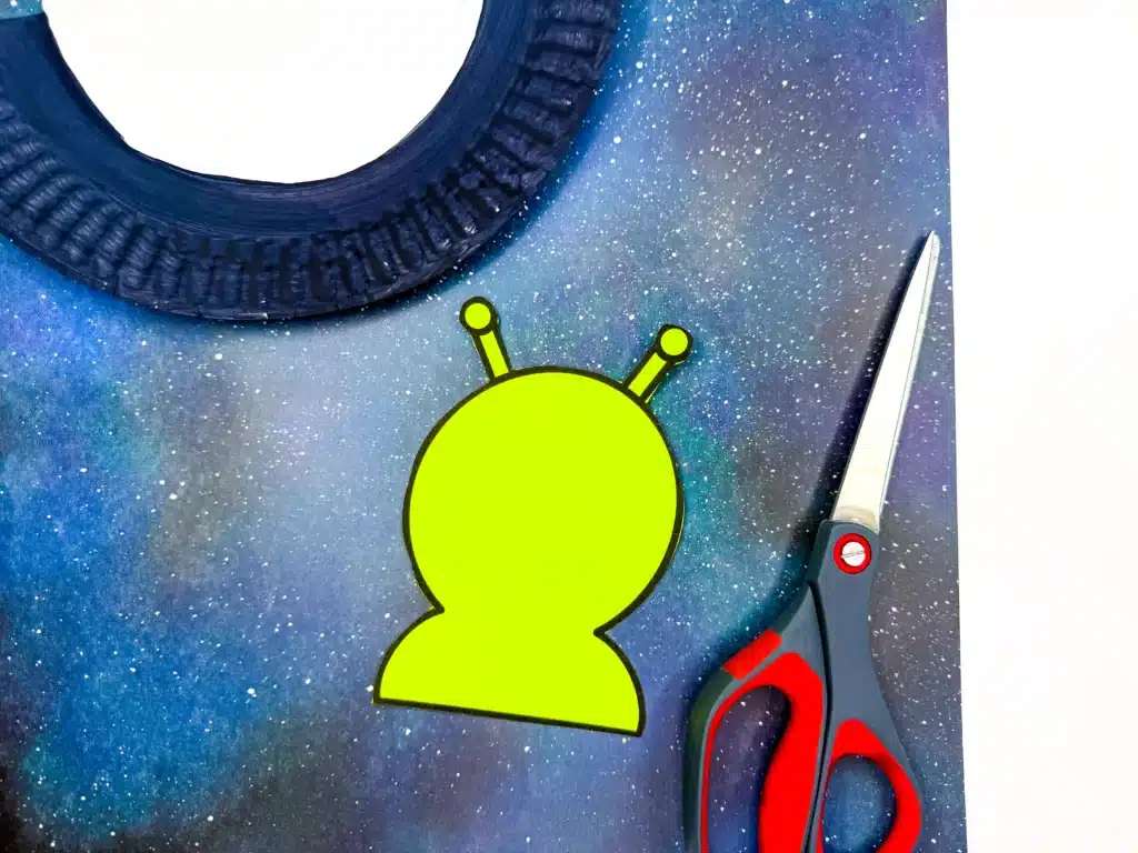 UFO Paper Plate Craft - Cultivating Brilliant Minds a paper alien next to the ufo craft