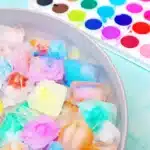 Ice Painting - Cultivating Brilliant Minds Bowl of pastel colored ice with a watercolor palette in the background.