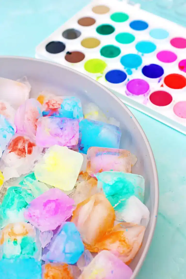 Bowl of pastel colored ice with a watercolor palette in the background.
