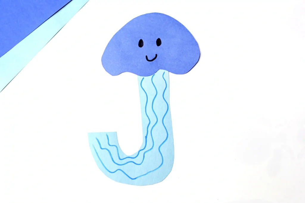 Letter J Jellyfish Craft - Cultivating Brilliant Minds an ocean craft cut out of blue construction paper to look like a jellyfish