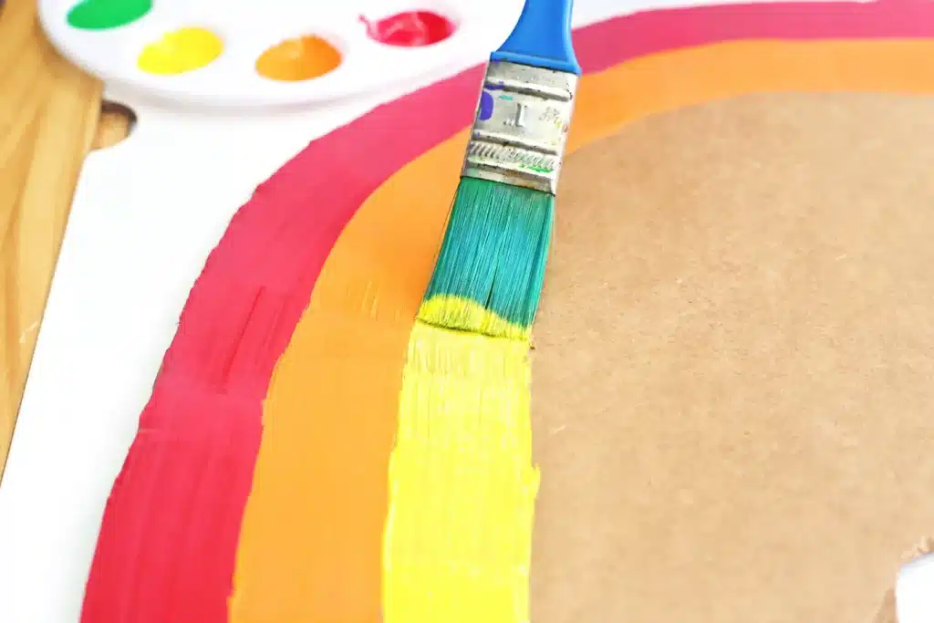 Cardboard Rainbow Streamers - Cultivating Brilliant Minds cardboard cut into the shape of a rainbow and painted to look like a rainbow