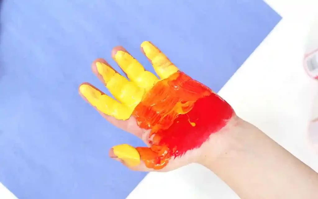 Father's Day Handprint Craft - Cultivating Brilliant Minds a child's hand painted yellow orange and red