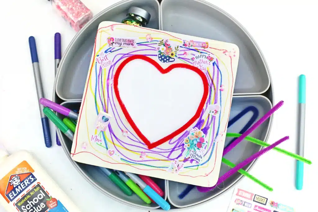 Picture Frame Decorating Tray - Cultivating Brilliant Minds a square wooden picture frame with a heart in the middle decorated with stickers and markers