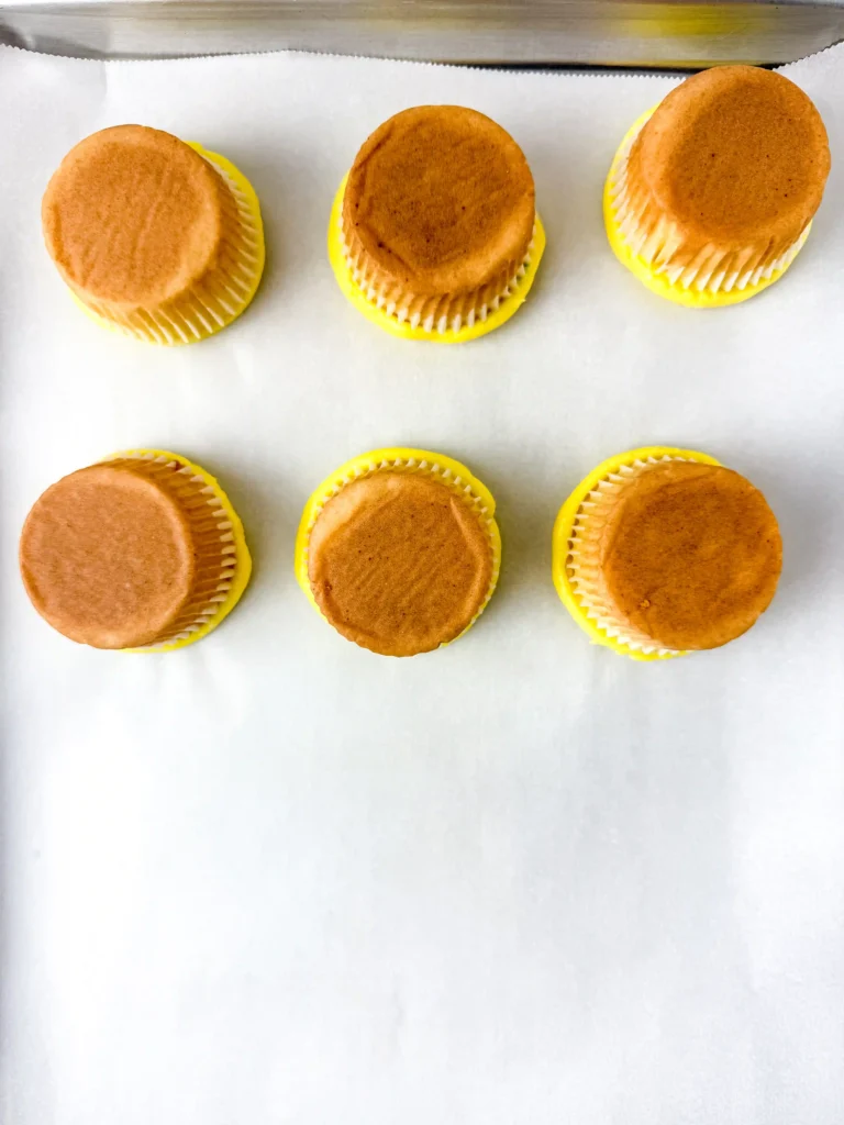Pineapple Cupcakes - Cultivating Brilliant Minds cupcakes with yellow icing upside down on parchment paper