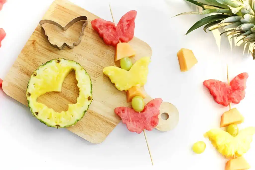 Spring Fruit Kabobs - Cultivating Brilliant Minds spring fruit kabobs on a wooden cutting board