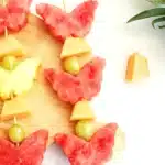 Spring Fruit Kabobs - Cultivating Brilliant Minds spring fruit kabobs on a wooden cutting board