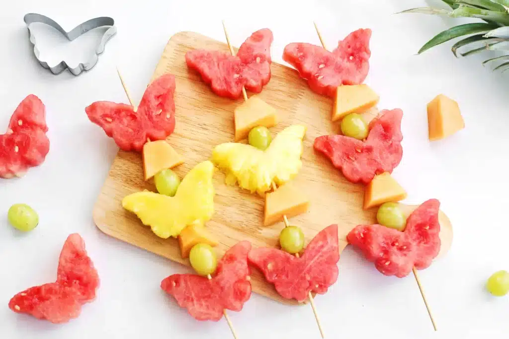Spring Fruit Kabobs - Cultivating Brilliant Minds spring fruit kabobs on a wooden cutting board