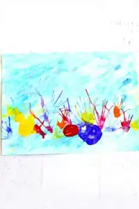 a coral blow painting with straws that has a watercolor background and coral made by blowing paint through a straw