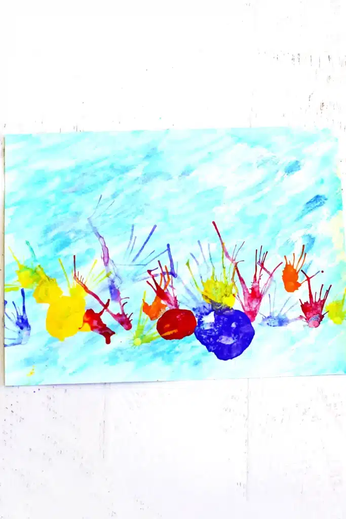 Coral Blow Painting With Straws - Cultivating Brilliant Minds a coral blow painting with straws that has a watercolor background and coral made by blowing paint through a straw