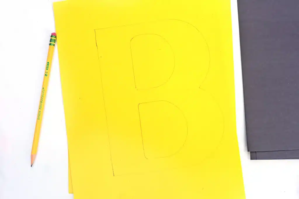 Letter B Bee Craft - Cultivating Brilliant Minds a yellow piece of construction paper with a capital b drawn on