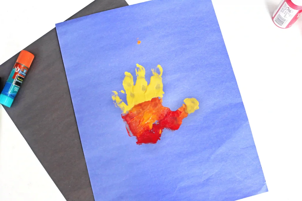 Father's Day Handprint Craft - Cultivating Brilliant Minds a red orange and yellow handprint on blue construction paper