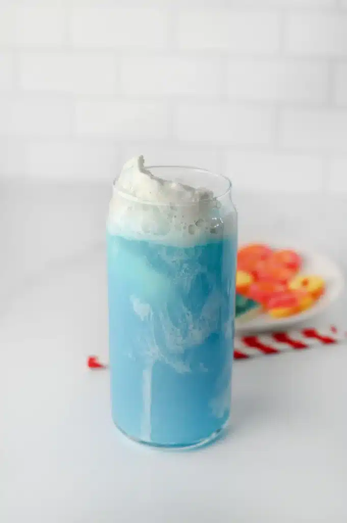 Shark Float for Shark Week - Cultivating Brilliant Minds a glass with vanilla ice cream and blue hawaiian punch