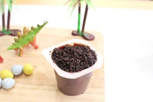 a chocolate pudding cup with crushed oreos on top