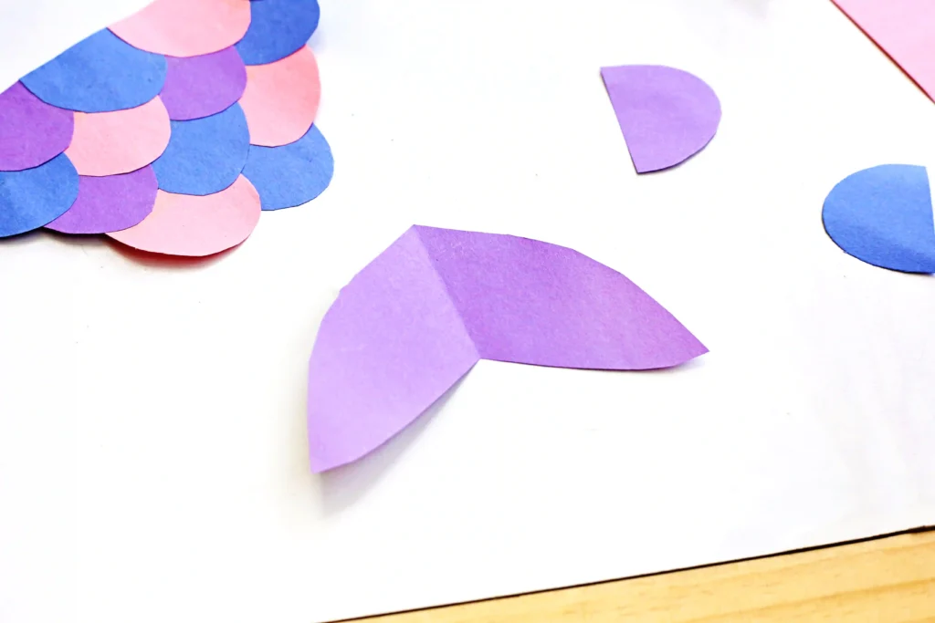 a mermaid tail cut out of purple construction paper