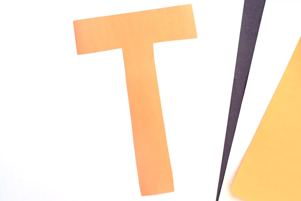 a letter T cut out of orange construction paper for this letter t craft