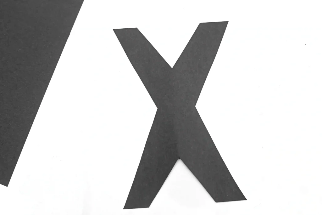 the letter x cut out of black construction paper for this letter craft for preschoolers
