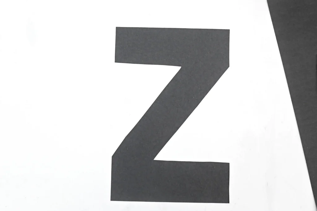 the letter Z cut out of black construction paper for this zebra craft for kids