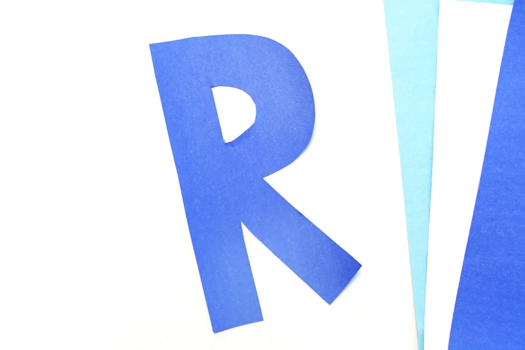 letter R cut out of blue construction paper